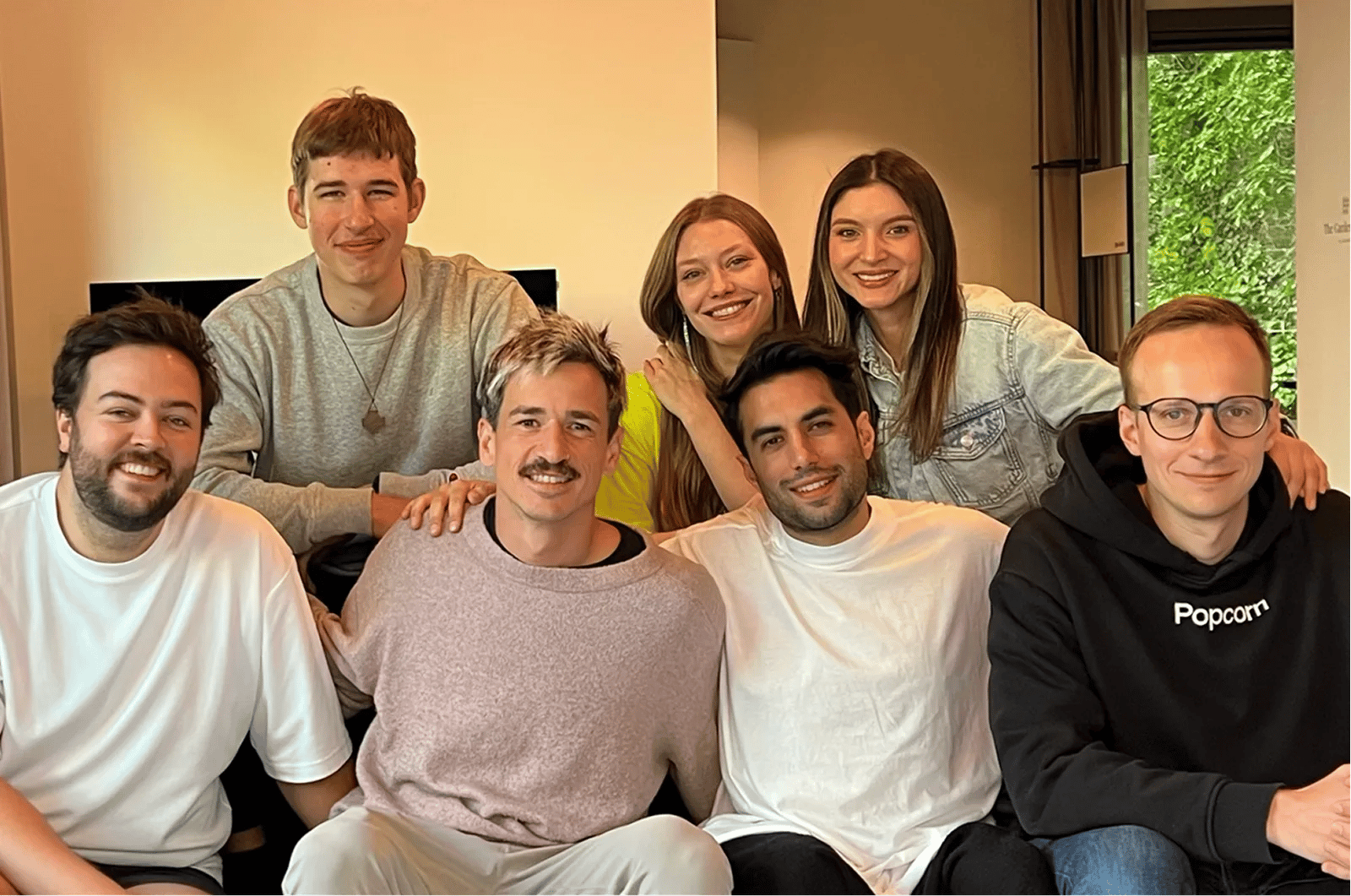 The Popcorn team gathered together on a couch